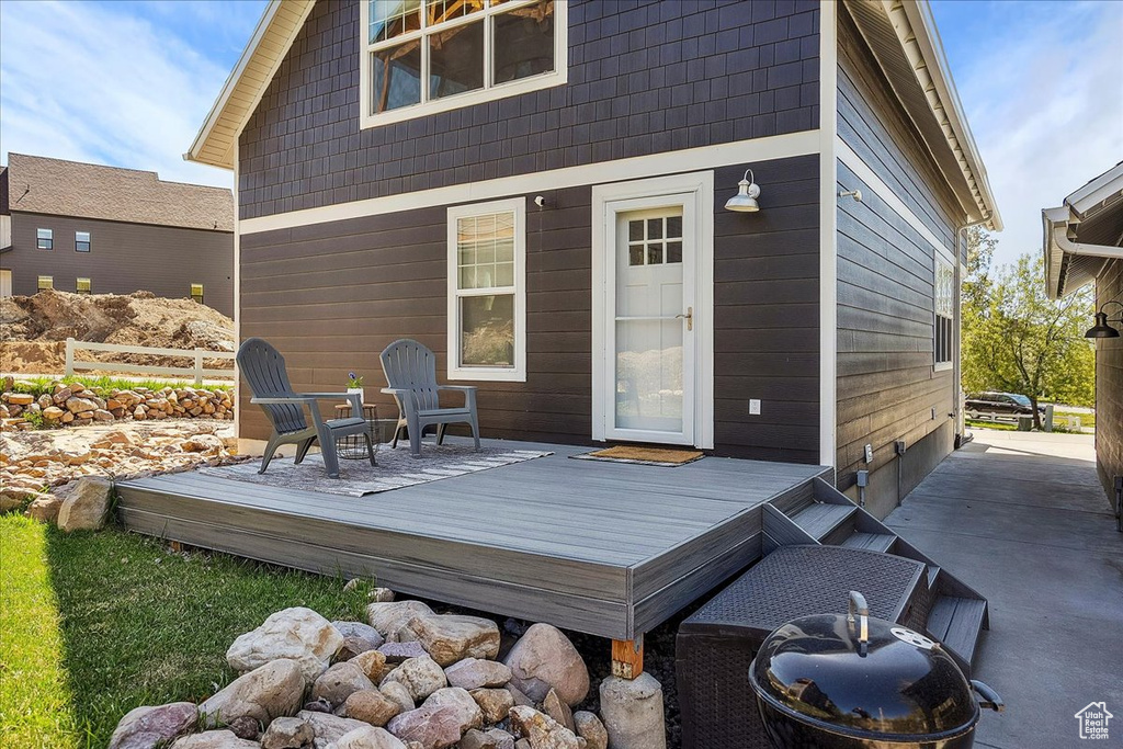Back of house with a deck