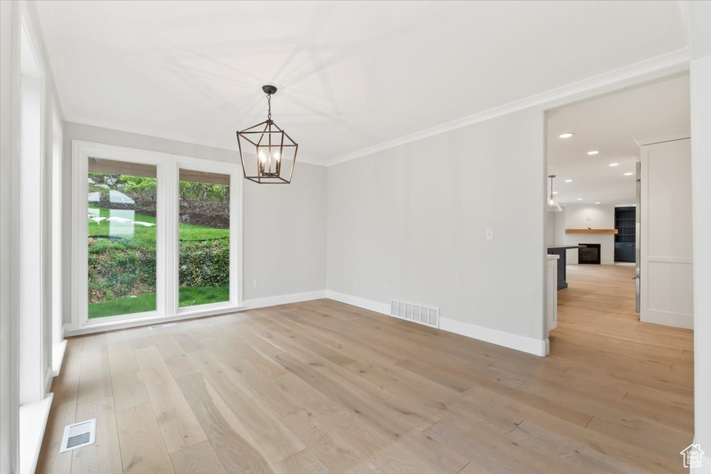 Unfurnished dining area with an inviting chandelier, recessed lighting, visible vents, and light wood-style floors