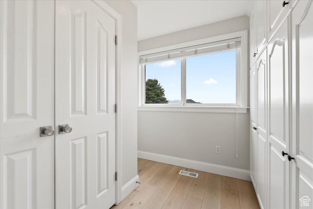 Unfurnished bedroom featuring light wood-type flooring, visible vents, and baseboards
