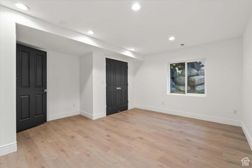 Unfurnished room featuring baseboards, recessed lighting, and light wood-type flooring