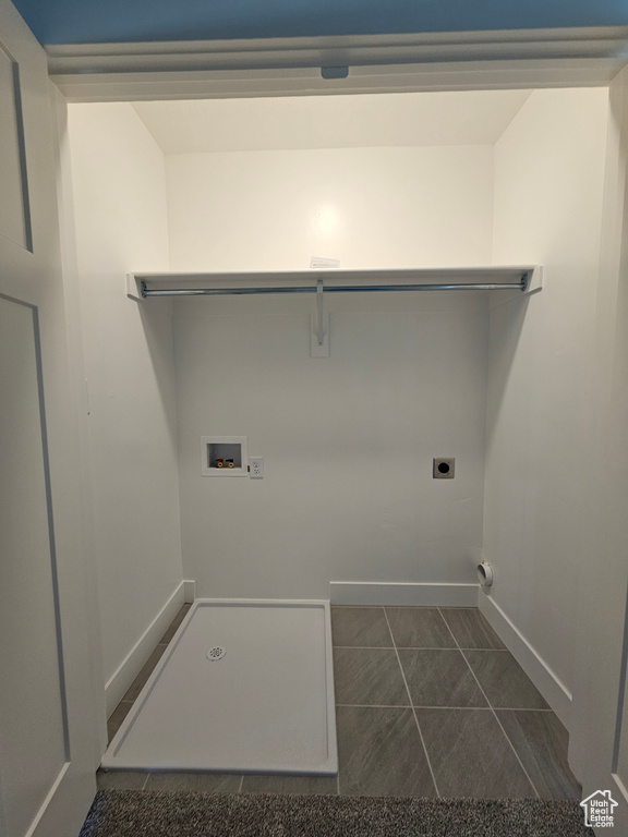 Washroom with hookup for a washing machine, baseboards, electric dryer hookup, and laundry area