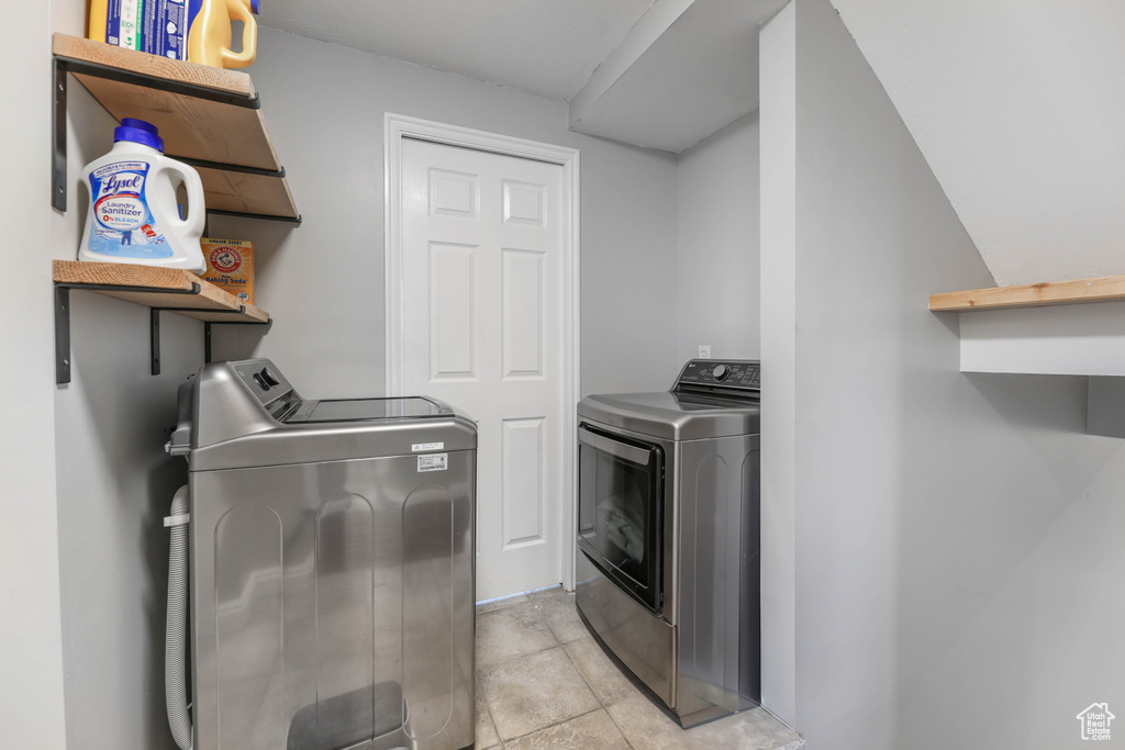 Clothes washing area featuring separate washer and dryer and laundry area
