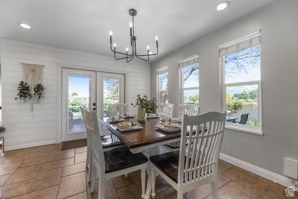 Dining room with recessed lighting, baseboards, french doors, and stone tile flooring