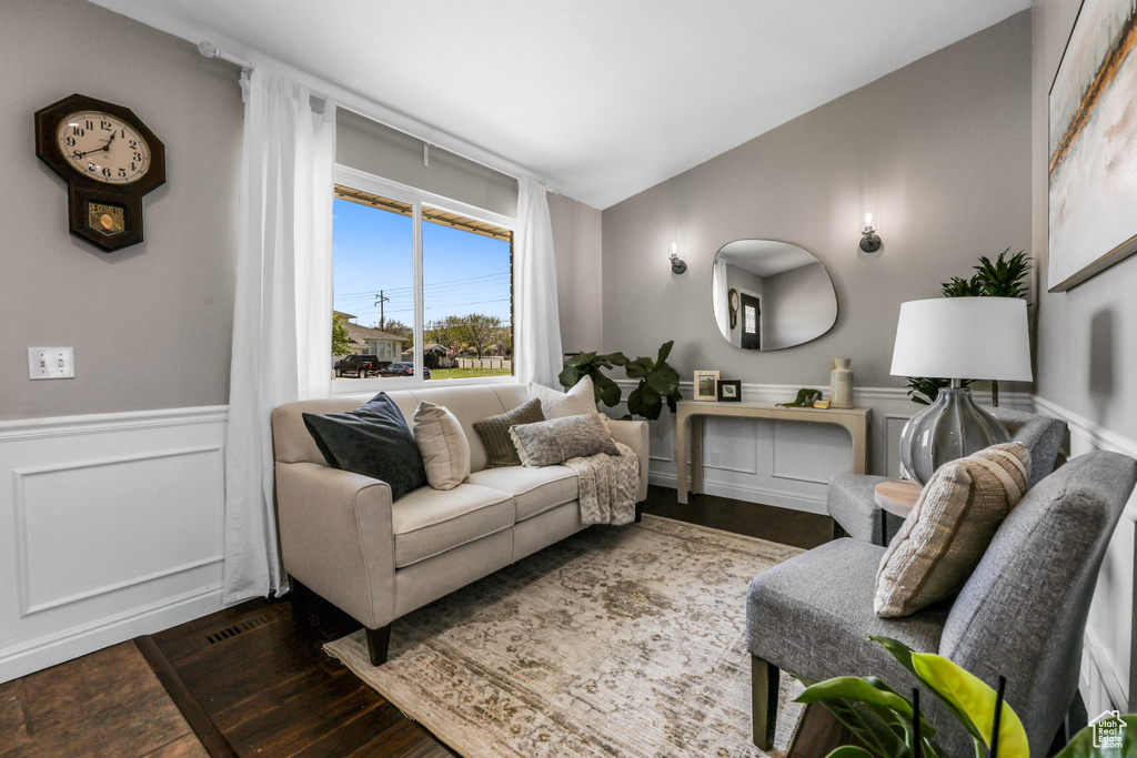 Living area with wainscoting and wood finished floors