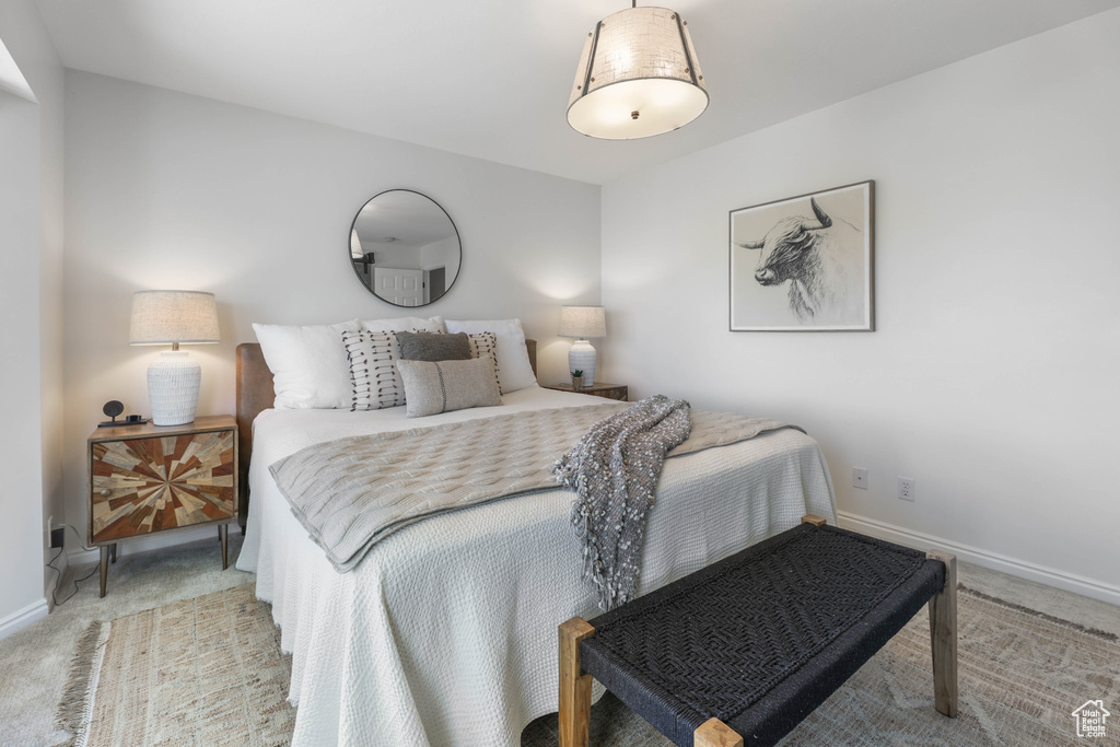 Bedroom featuring baseboards and carpet
