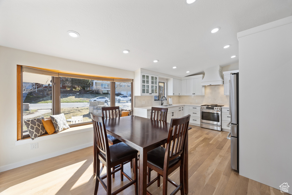 Dining space featuring recessed lighting, light wood finished floors, and baseboards