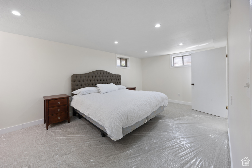 Bedroom featuring baseboards, recessed lighting, and light colored carpet