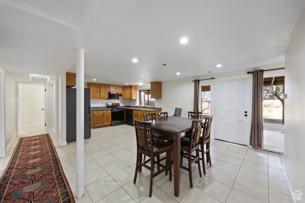 Dining room featuring recessed lighting and light tile patterned floors