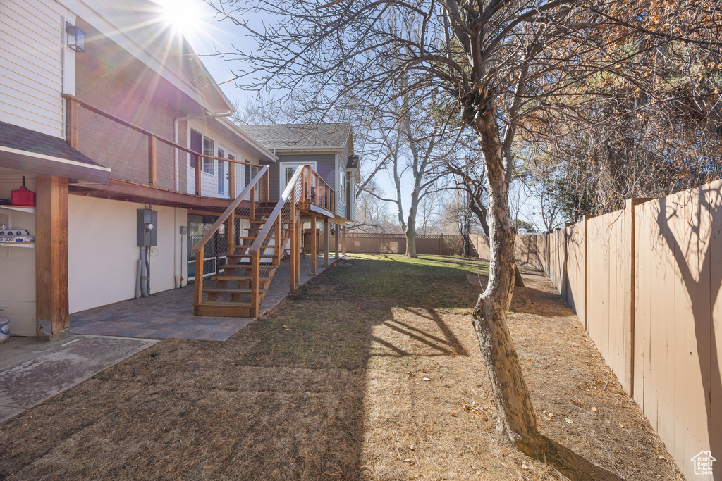 View of yard featuring stairway, a deck, a patio, and a fenced backyard