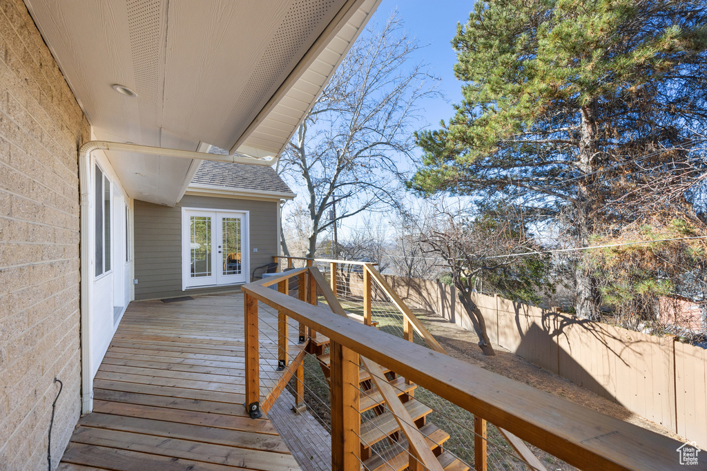 Deck with french doors and a fenced backyard