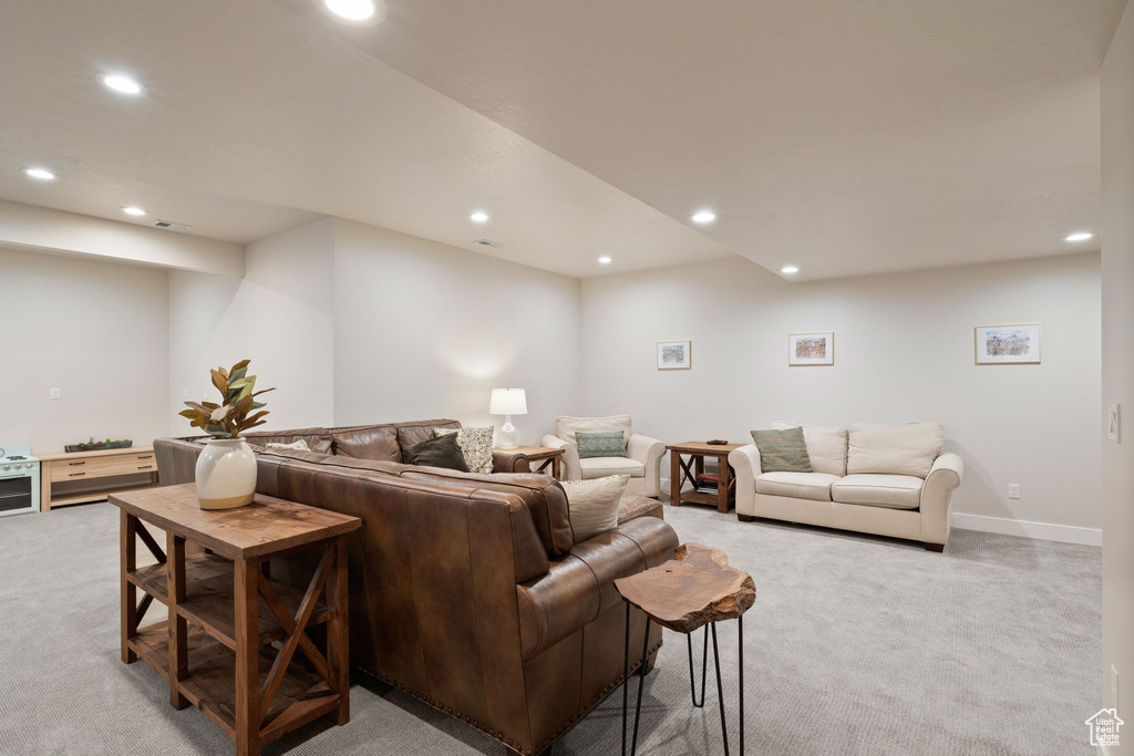 Living area with recessed lighting and light colored carpet