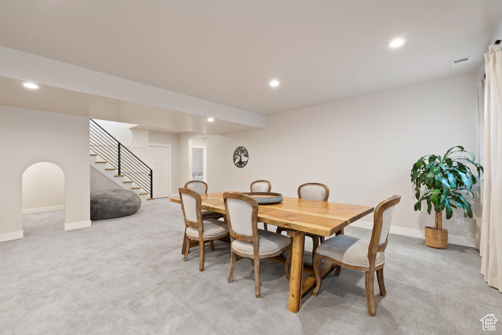 Dining area with stairway, light colored carpet, and recessed lighting