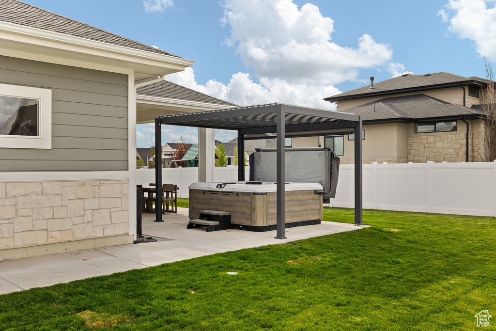 View of yard featuring a patio, a fenced backyard, and a hot tub