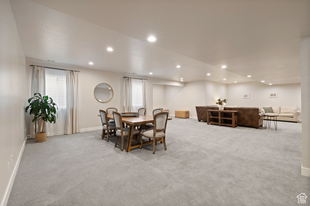 Dining space with recessed lighting, light colored carpet, and baseboards