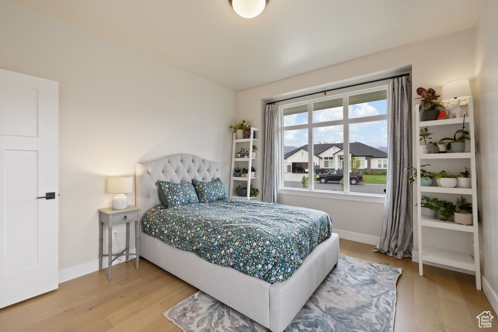 Bedroom featuring baseboards and wood finished floors