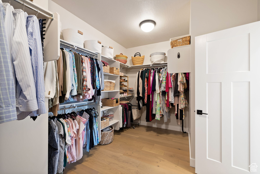 Spacious closet featuring light wood-type flooring