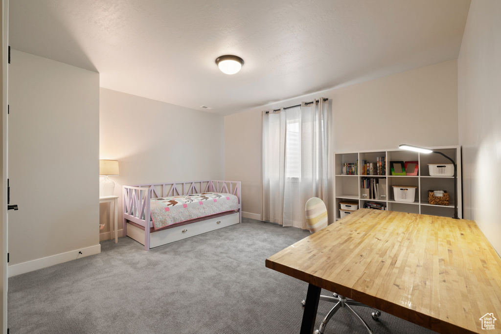 Bedroom featuring baseboards and carpet floors