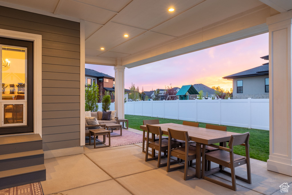View of patio featuring an outdoor hangout area, outdoor dining space, and a fenced backyard