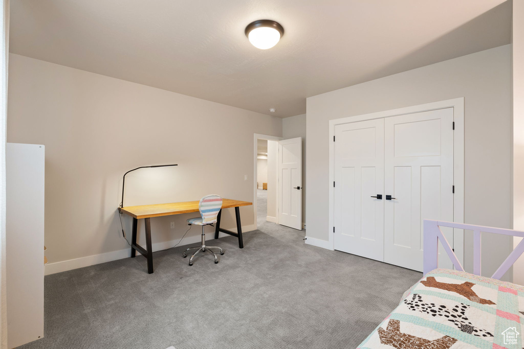 Bedroom with a closet, carpet, and baseboards