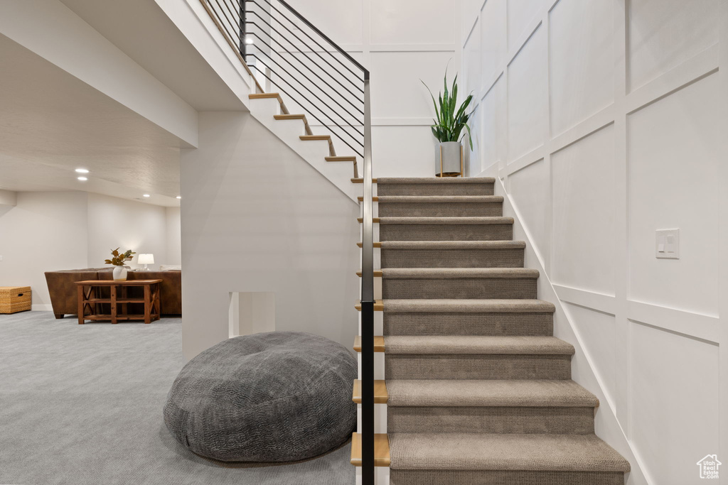 Staircase featuring recessed lighting and carpet flooring