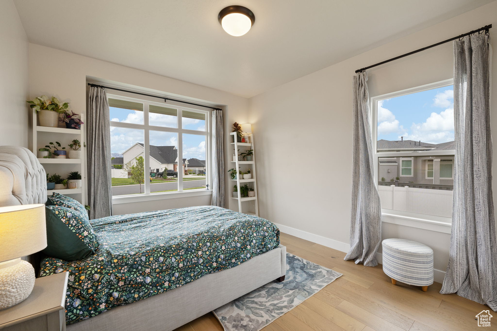 Bedroom featuring wood finished floors and baseboards