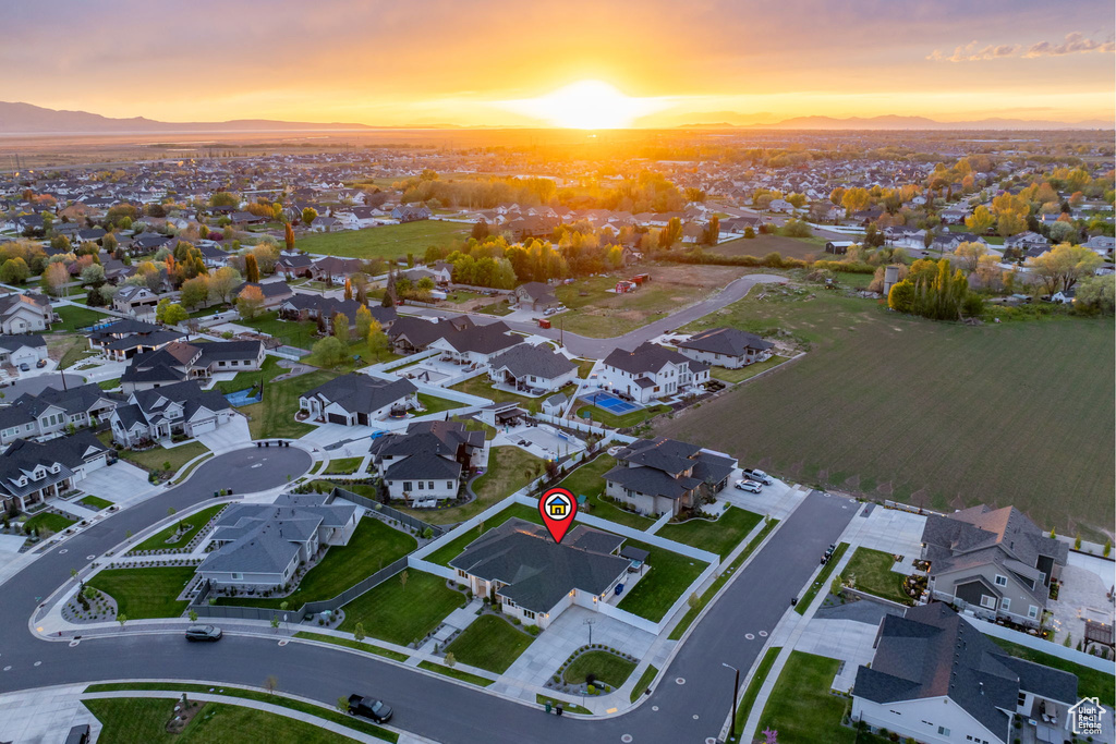 Aerial view at dusk featuring a mountain view and a residential view