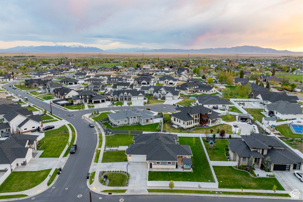 Aerial view at dusk featuring a mountain view and a residential view