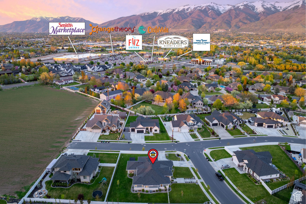 Aerial view at dusk featuring a mountain view and a residential view