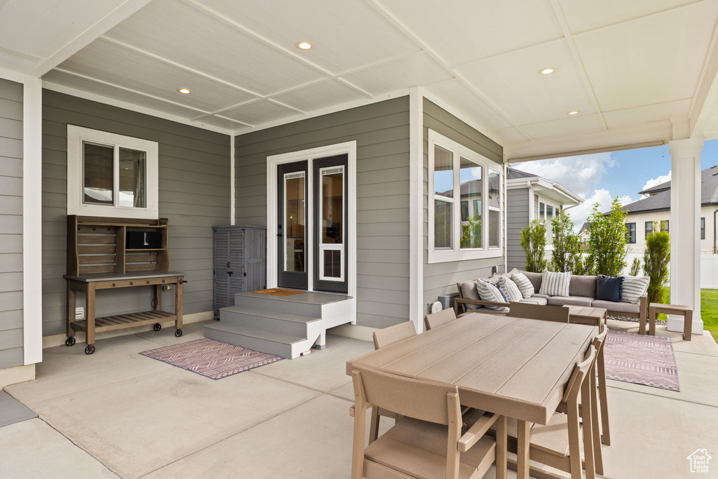 View of patio with an outdoor hangout area