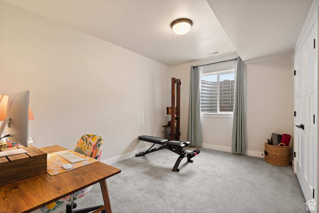 Carpeted office with visible vents and baseboards