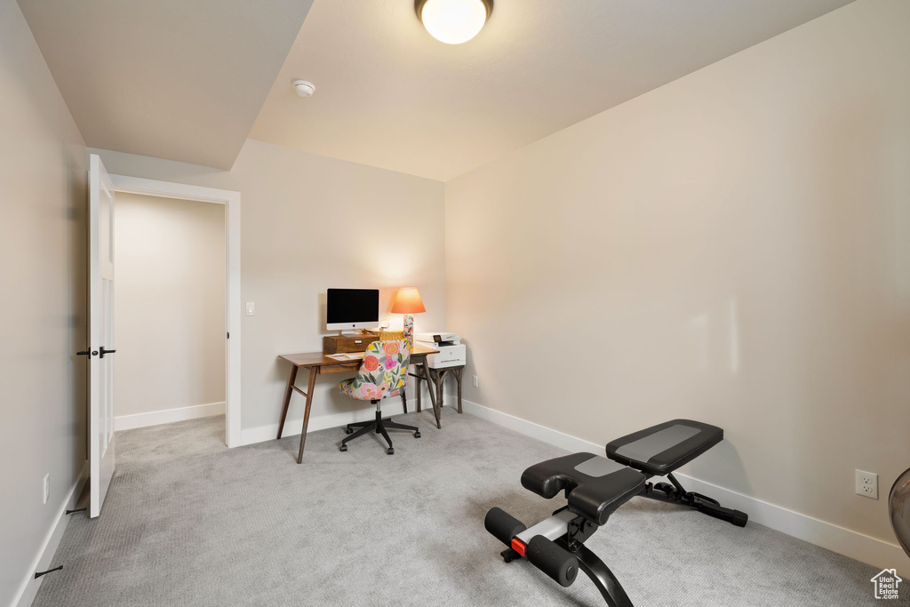 Carpeted office space with baseboards
