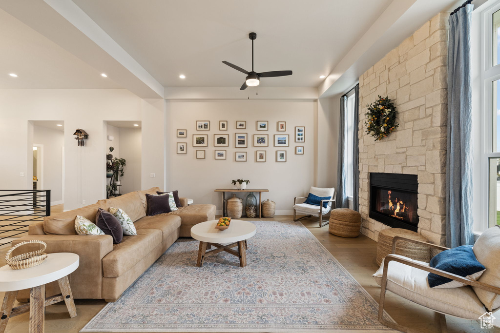 Living area featuring recessed lighting, a ceiling fan, and a stone fireplace