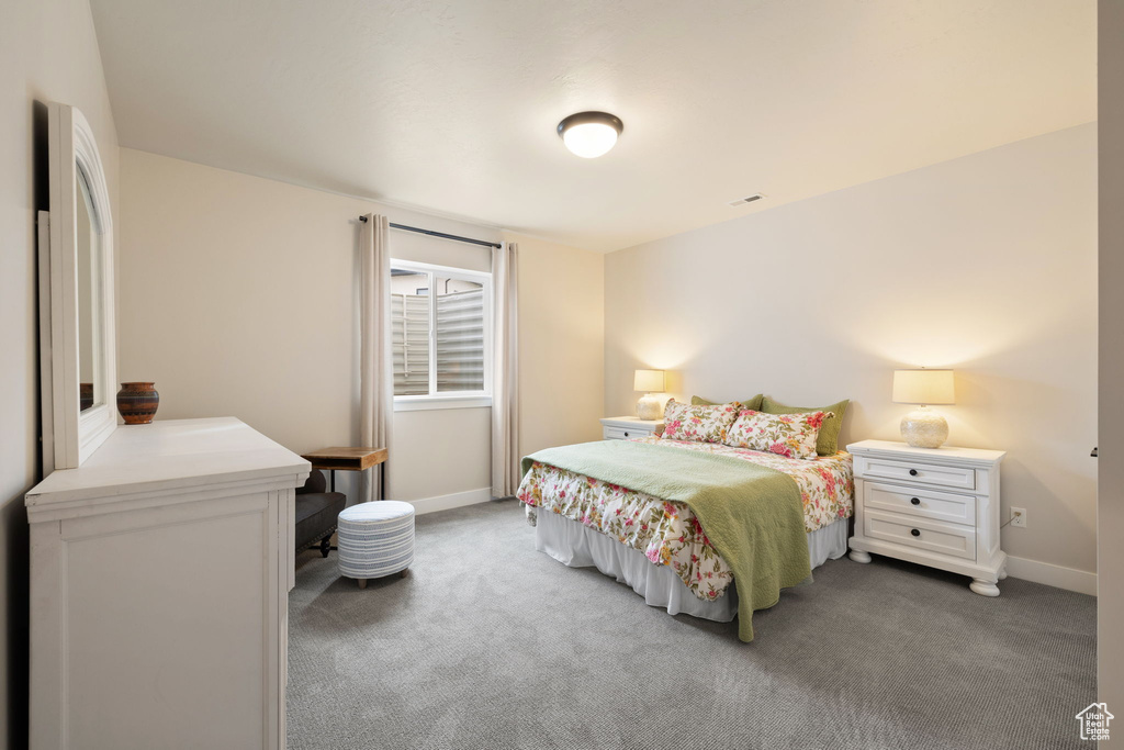 Bedroom with baseboards and carpet