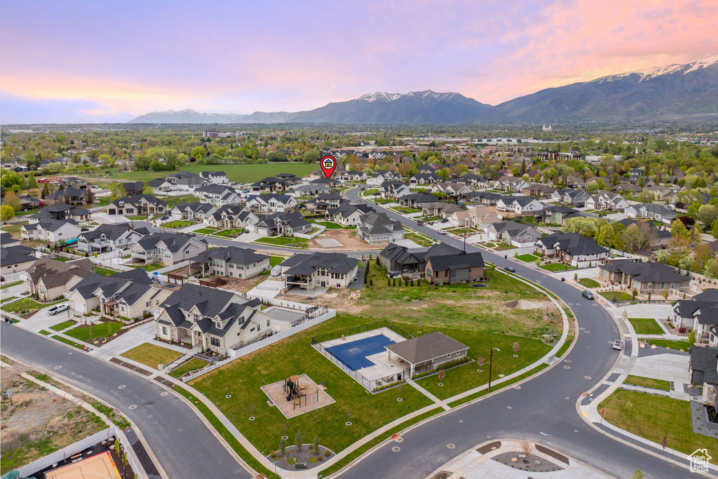 Aerial view at dusk featuring a mountain view and a residential view