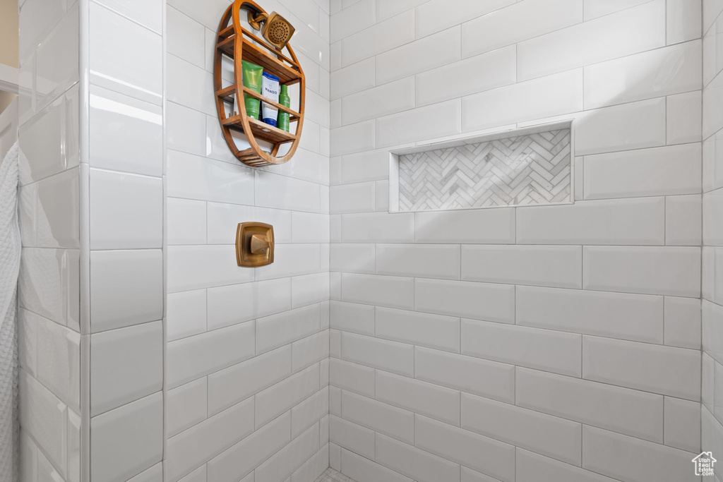 Full bath featuring tiled shower