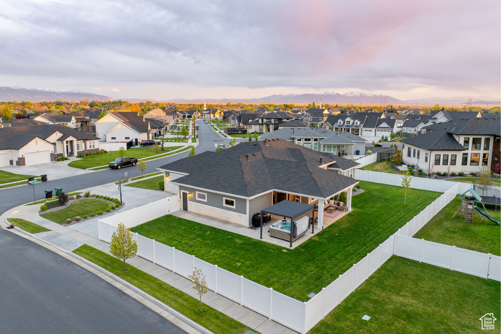 Birds eye view of property with a mountain view and a residential view