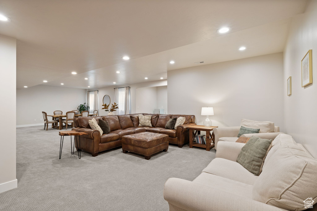 Living area featuring recessed lighting, light colored carpet, and baseboards