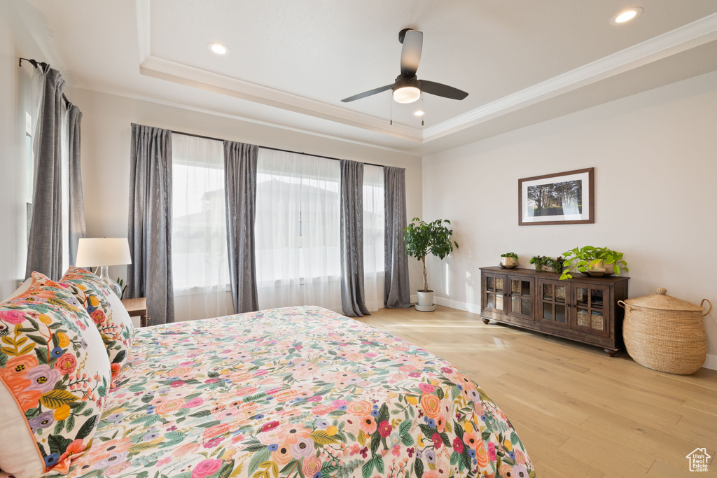 Bedroom featuring recessed lighting, a raised ceiling, and multiple windows