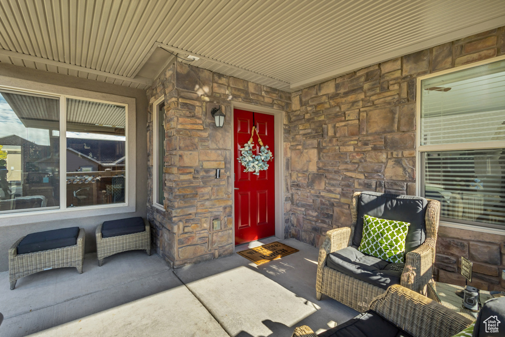 Entrance to property featuring stone siding