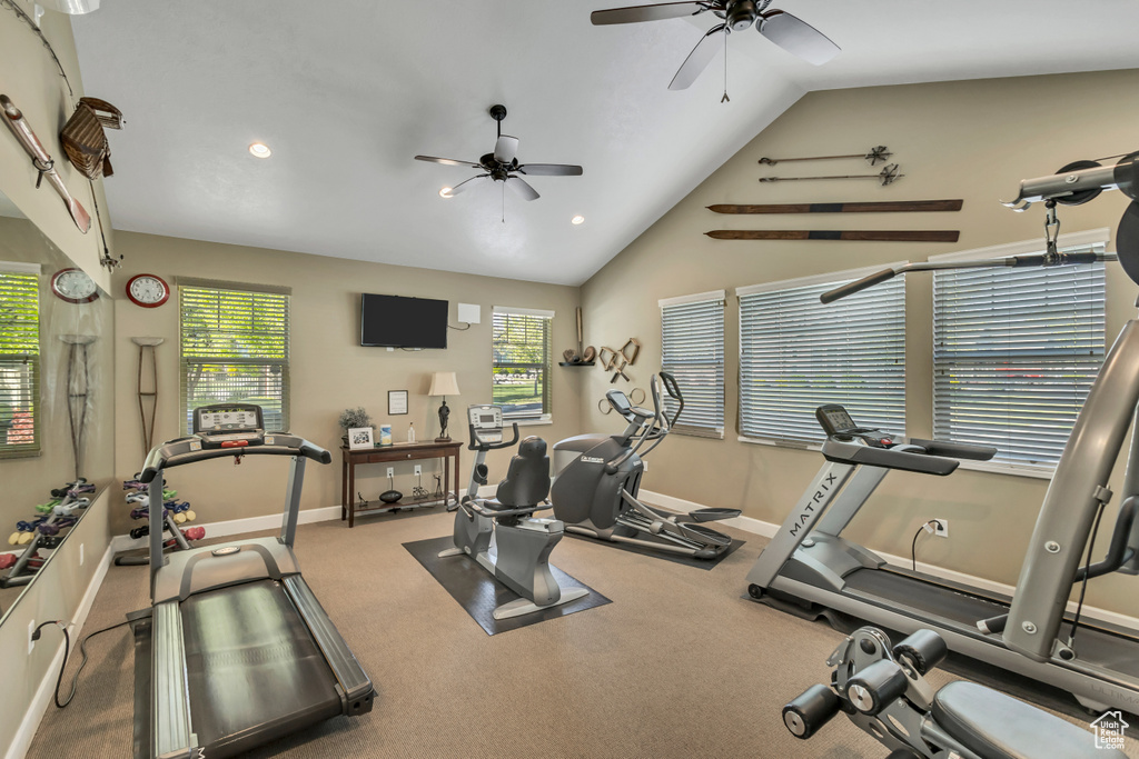 Workout room with a ceiling fan, baseboards, vaulted ceiling, and recessed lighting