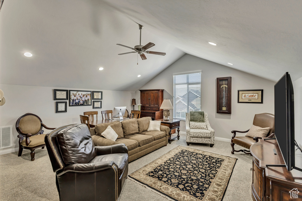 Living room with ceiling fan, baseboards, lofted ceiling, light carpet, and recessed lighting