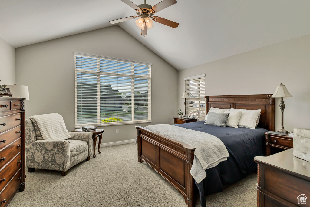 Bedroom with baseboards, light carpet, ceiling fan, and lofted ceiling