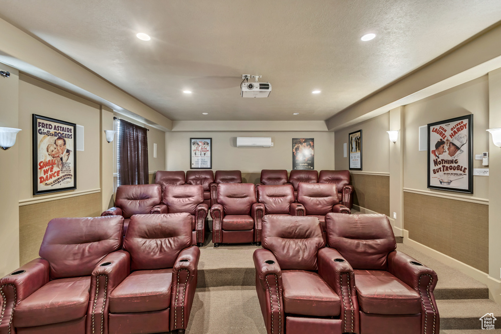 Carpeted home theater room with recessed lighting and a wall mounted AC