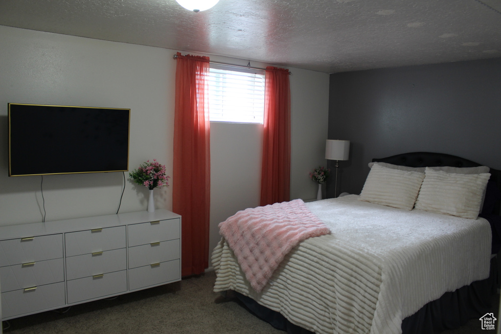 Bedroom with carpet floors and a textured ceiling
