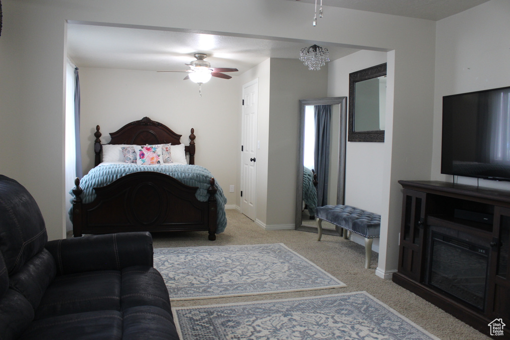 Bedroom featuring baseboards, carpet, and ceiling fan