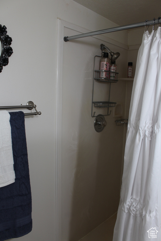 Bathroom featuring a shower with shower curtain