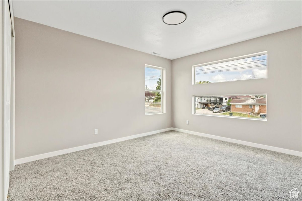 Carpeted spare room with baseboards