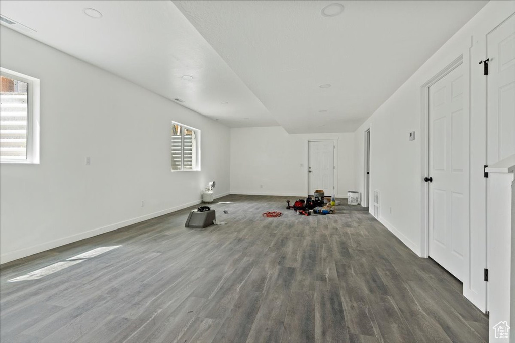 Interior space with baseboards, wood finished floors, and a wealth of natural light
