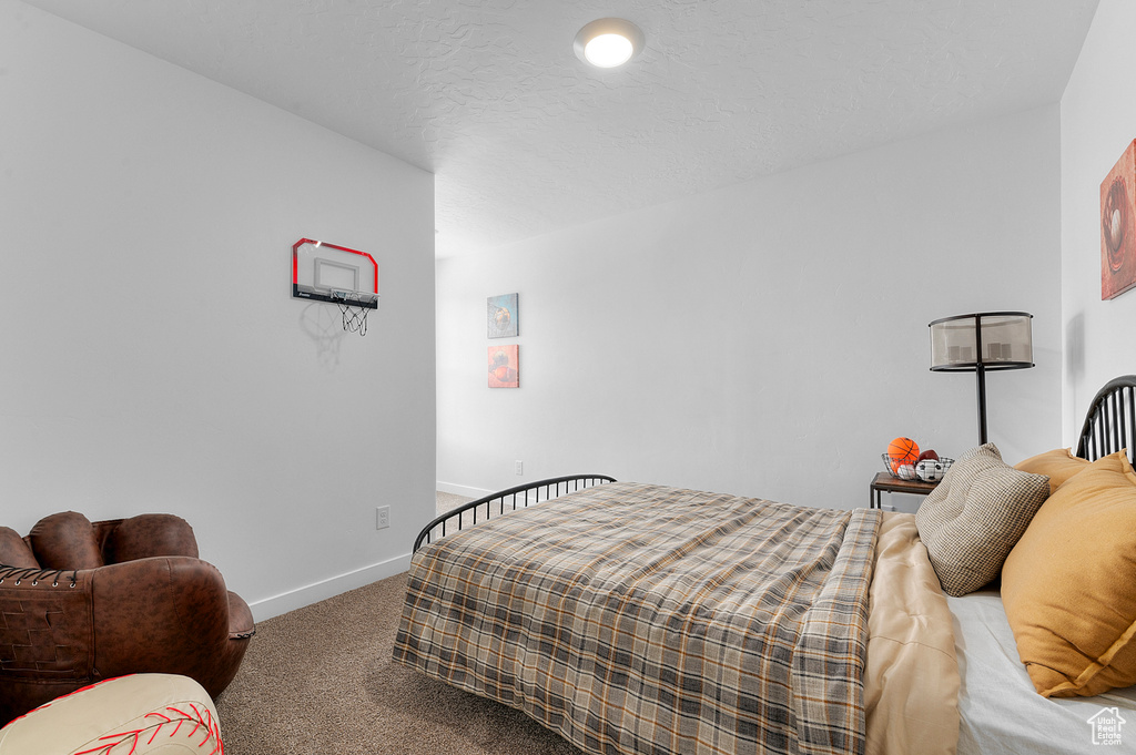 Bedroom featuring baseboards and carpet