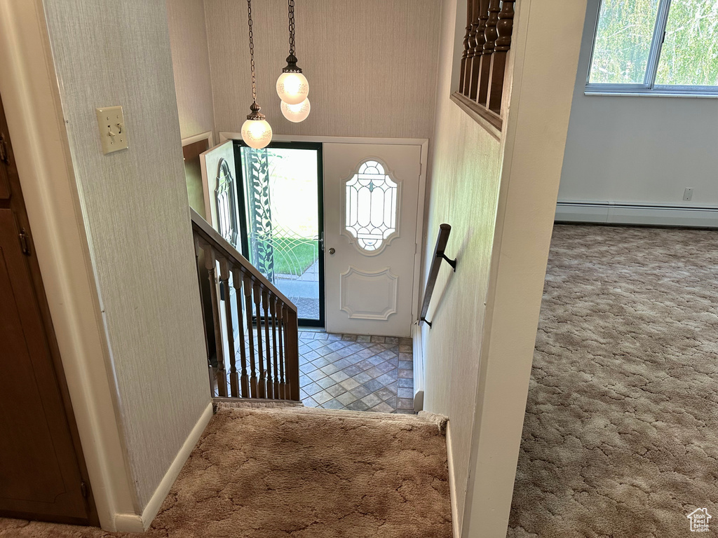 Foyer with baseboard heating, baseboards, carpet, and wallpapered walls